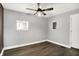 Light-filled bedroom with ceiling fan and new floors is freshly painted in neutral tones at 2936 N Gladstone Ave, Indianapolis, IN 46218