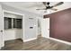 Cozy bedroom with ceiling fan, closet with shelving, and a freshly painted accent wall at 2936 N Gladstone Ave, Indianapolis, IN 46218