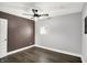 Updated bedroom features a ceiling fan, a freshly painted accent wall, and new floors at 2936 N Gladstone Ave, Indianapolis, IN 46218