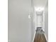 Hallway with hardwood floors and neutral walls, provides access to the home's interior at 2936 N Gladstone Ave, Indianapolis, IN 46218