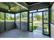 Enclosed front porch with ceiling fan, perfect for relaxing and enjoying the outdoors at 2936 N Gladstone Ave, Indianapolis, IN 46218