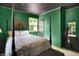 Stylish green bedroom showcasing a distinctive ceiling, a comfortable bed, and eye-catching decor at 332 Campus Ln, Indianapolis, IN 46219