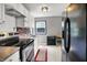 Efficient kitchen with white cabinets, stainless steel appliances, and a brick accent wall at 332 Campus Ln, Indianapolis, IN 46219