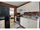 Clean kitchen with stainless steel appliances, white cabinets, and brick backsplash at 332 Campus Ln, Indianapolis, IN 46219