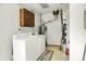 Functional laundry room with a washing machine, a dryer, and practical storage solutions at 332 Campus Ln, Indianapolis, IN 46219