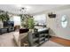 Inviting living room featuring lots of plants, carpeted floors, and a cozy seating area at 332 Campus Ln, Indianapolis, IN 46219