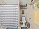 Neutral bathroom featuring a blue and white striped shower curtain and toilet at 334 E Pennsylvania St, Shelbyville, IN 46176