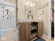 Well-lit bathroom with double vessel sinks, wood cabinet, and decorative accents at 334 E Pennsylvania St, Shelbyville, IN 46176