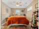 Cozy bedroom featuring a ceiling fan, colorful rugs, and warm lighting at 334 E Pennsylvania St, Shelbyville, IN 46176