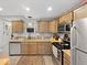 Modern kitchen with wood cabinets, stainless steel appliances, and stylish countertops at 334 E Pennsylvania St, Shelbyville, IN 46176
