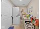 Bright laundry room with stacked washer/dryer and storage at 334 E Pennsylvania St, Shelbyville, IN 46176