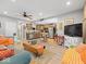 Open-concept living area with kitchen view, featuring hardwood floors and cozy furnishings at 334 E Pennsylvania St, Shelbyville, IN 46176