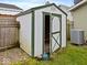 Backyard shed with an open door and green trim at 334 E Pennsylvania St, Shelbyville, IN 46176