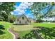 Expansive backyard features a personal putting green and lush green lawn at 3398 Nottinghill Blvd, Plainfield, IN 46168
