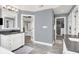 Bright bathroom with white vanities, a walk-in closet, gray walls, and tile flooring at 3398 Nottinghill Blvd, Plainfield, IN 46168