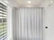 Bright bathroom featuring a shower with a stylish white shower curtain and a window with plantation shutters at 3398 Nottinghill Blvd, Plainfield, IN 46168