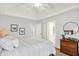 Comfortable bedroom featuring stylish decor, complemented by a ceiling fan and ample natural light at 3398 Nottinghill Blvd, Plainfield, IN 46168