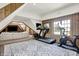 Bright bonus room with workout equipment, paneled walls, and natural light at 3398 Nottinghill Blvd, Plainfield, IN 46168