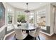 Dining room with hardwood floors, chandelier, and large windows overlooking the outdoor entertainment area at 3398 Nottinghill Blvd, Plainfield, IN 46168