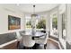 Bright dining room with modern chandelier, bay windows, hardwood floors and neutral paint at 3398 Nottinghill Blvd, Plainfield, IN 46168