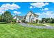 Beautiful home featuring manicured landscaping, circular driveway, and an attached garage at 3398 Nottinghill Blvd, Plainfield, IN 46168