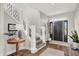 Grand foyer boasts hardwood floors, a staircase with decorative iron, and a stylish entrance door at 3398 Nottinghill Blvd, Plainfield, IN 46168