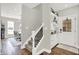 Welcoming foyer showcasing hardwood floors, a staircase, and a convenient bar area next to the front door at 3398 Nottinghill Blvd, Plainfield, IN 46168