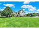 Beautifully landscaped front yard with a large lawn and mature trees of this luxury home at 3398 Nottinghill Blvd, Plainfield, IN 46168
