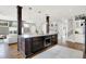 Kitchen island has bar seating, a built-in microwave, and a view into the living area at 3398 Nottinghill Blvd, Plainfield, IN 46168
