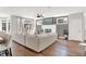 Open living room with a fireplace, large sofa, hardwood floors, and natural light through the windows at 3398 Nottinghill Blvd, Plainfield, IN 46168