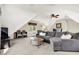 Inviting living room area featuring plush seating, a ceiling fan, and natural light at 3398 Nottinghill Blvd, Plainfield, IN 46168