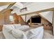 Inviting living room featuring wood paneling, exposed beams, a modern light fixture, and a comfortable sectional sofa at 3398 Nottinghill Blvd, Plainfield, IN 46168