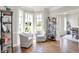 Bright and airy living room featuring two comfortable chairs, hardwood floors, and shelving at 3398 Nottinghill Blvd, Plainfield, IN 46168