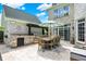 Outdoor kitchen and dining area with a built-in grill and seating for eight at 3398 Nottinghill Blvd, Plainfield, IN 46168