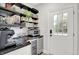 Butler's pantry with open shelving, countertops, wine cooler, and access to the exterior at 3398 Nottinghill Blvd, Plainfield, IN 46168