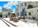 Outdoor kitchen and patio area with dining table and wicker seating near the house at 3398 Nottinghill Blvd, Plainfield, IN 46168