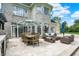 A lovely patio with an outdoor dining table and chairs, and a wicker sofa and chairs at 3398 Nottinghill Blvd, Plainfield, IN 46168