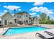 Backyard pool with travertine patio and lounge chairs for relaxing on a sunny day at 3398 Nottinghill Blvd, Plainfield, IN 46168