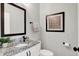 Cozy powder room with a granite counter, modern fixtures, and decorative framed art at 3398 Nottinghill Blvd, Plainfield, IN 46168