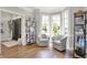 Inviting sitting area featuring two armchairs, hardwood floors, and natural light from the surrounding windows at 3398 Nottinghill Blvd, Plainfield, IN 46168