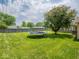 Large backyard with a well maintained lawn and a trampoline for outdoor enjoyment at 3538 Whalen Ave, Indianapolis, IN 46227
