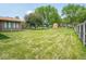 Expansive backyard featuring lush greenery, mature trees, and recreational area with trampoline at 3538 Whalen Ave, Indianapolis, IN 46227