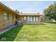 Backyard showcasing a well-maintained lawn, the home's exterior and access to a side yard at 3538 Whalen Ave, Indianapolis, IN 46227