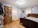 Bedroom with hardwood floors, antique furniture, and natural light streaming through the decorated windows at 3538 Whalen Ave, Indianapolis, IN 46227