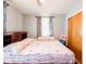 Cozy bedroom featuring a large bed, soft lighting, and window with stylish curtains at 3538 Whalen Ave, Indianapolis, IN 46227
