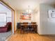 View of the dining area featuring a wooden table set for four, with an adjacent living room at 3538 Whalen Ave, Indianapolis, IN 46227
