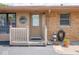 Inviting front entrance with a small porch, landscaped yard, and a full storm door at 3538 Whalen Ave, Indianapolis, IN 46227