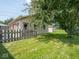 Exterior of detached garage in backyard with a small wooden fence at 3538 Whalen Ave, Indianapolis, IN 46227