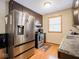 Efficient kitchen featuring stainless steel appliances, dark cabinets, and natural light from a nearby window at 3538 Whalen Ave, Indianapolis, IN 46227