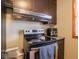 Kitchen with stainless steel range oven and dark cabinetry with light counter tops and lighting at 3538 Whalen Ave, Indianapolis, IN 46227